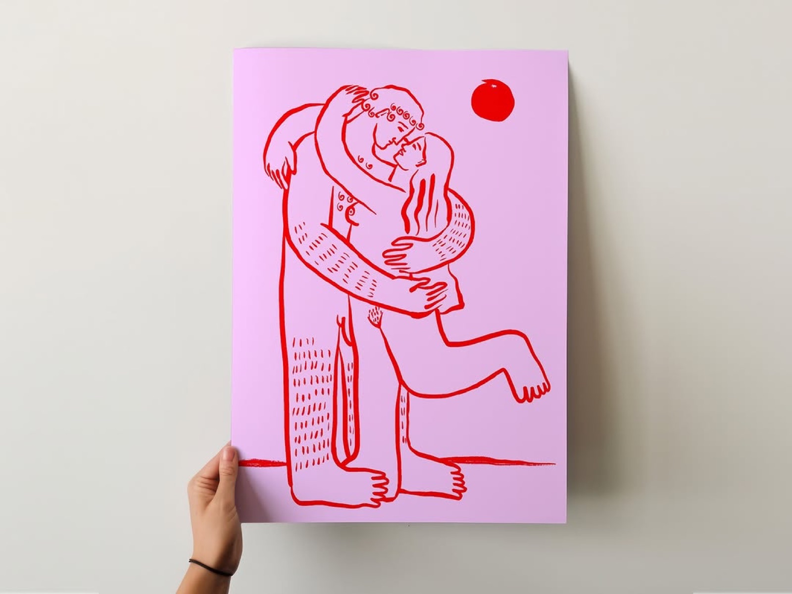 An illustrated art print of two figures embracing, held against a wall