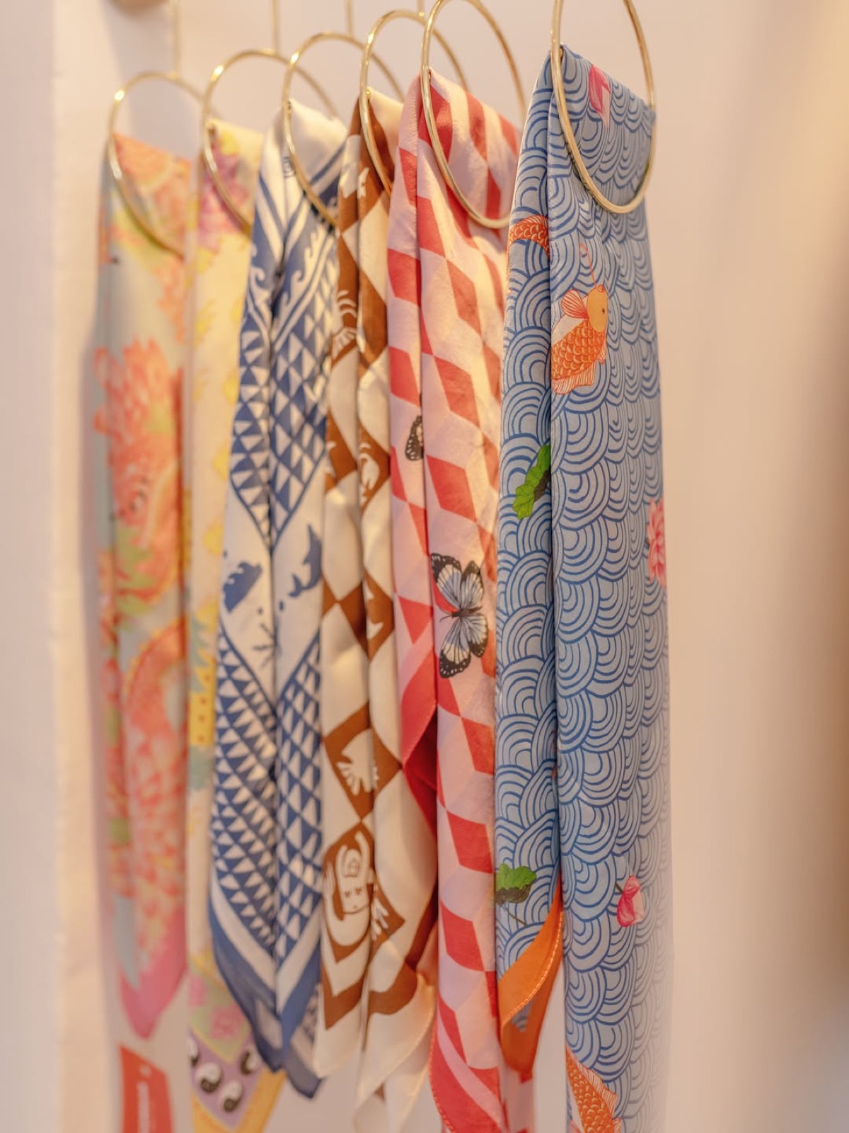 Patterned scarves hanging in a row